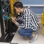 young-engineer-working-server-room-high-angle-view Patrabrothers